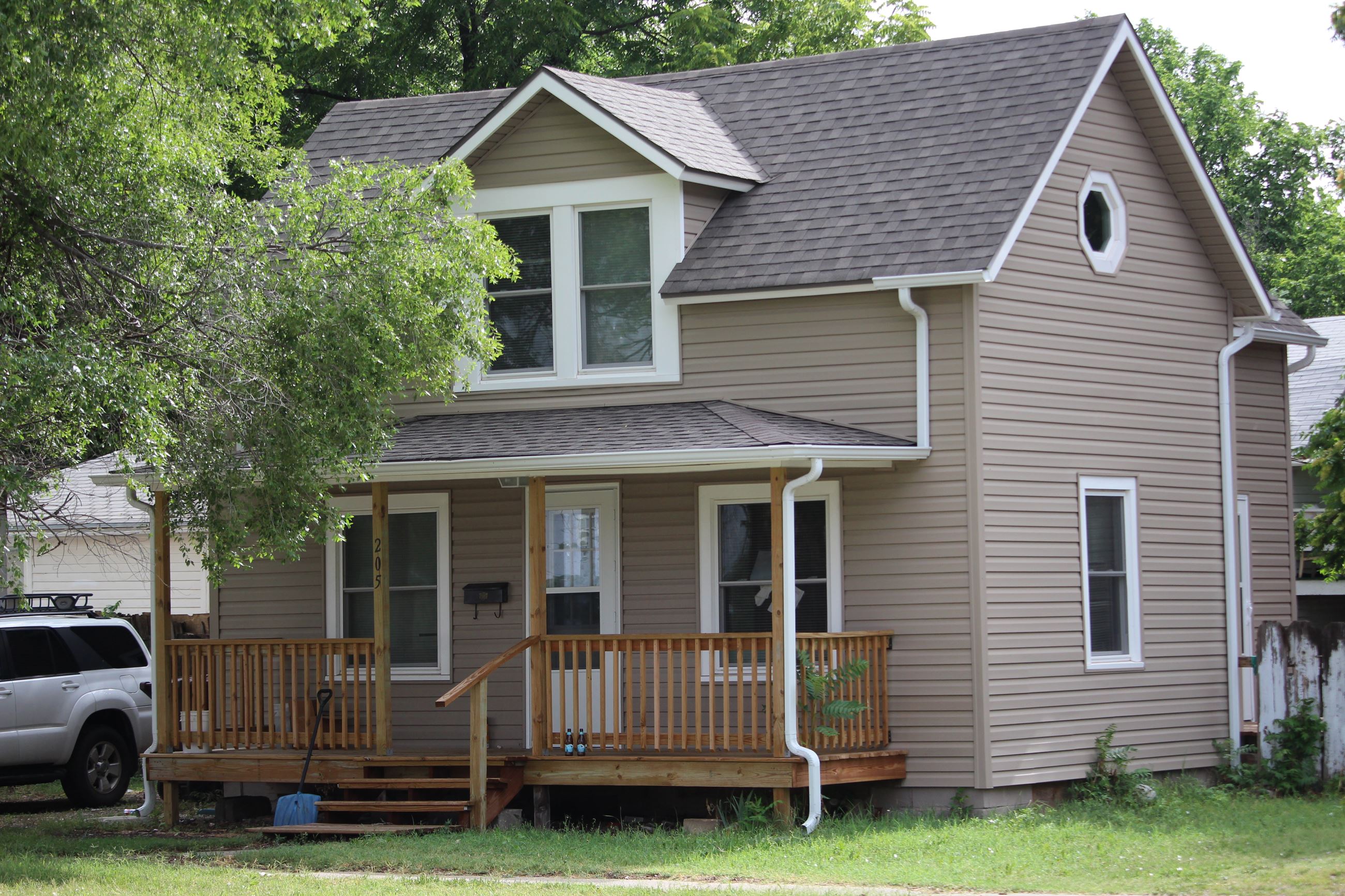 Remodeled two-story home with tan-colored siding